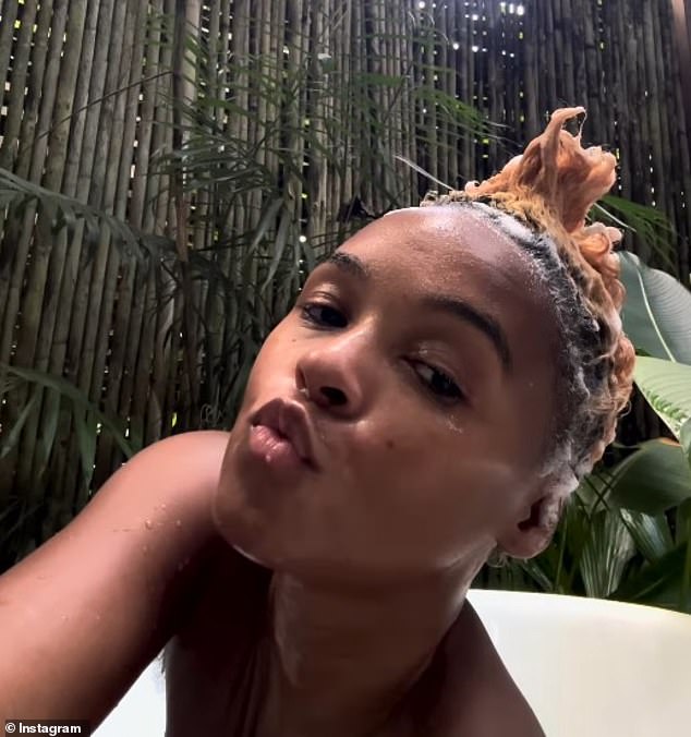 Monae added a makeup-free clip of herself bathing in an outdoor shower and playfully styling her short locks into a Mohawk