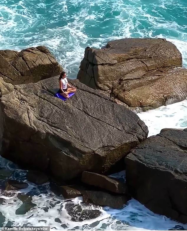 Kamila had been sitting on the rocks, apparently meditating, as the water became more violent