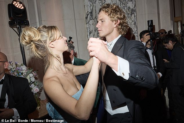 Her famous parents Chris and Gwyneth couldn't keep their eyes off their daughter as she danced around the room