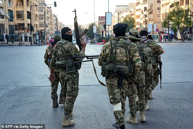 Anti-government fighters patrol central Aleppo on November 30, 2024.