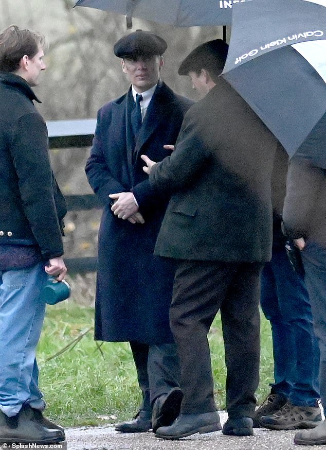 Murphy and Lee sheltered under parasols between takes as it started to rain in North East Wales on Sunday