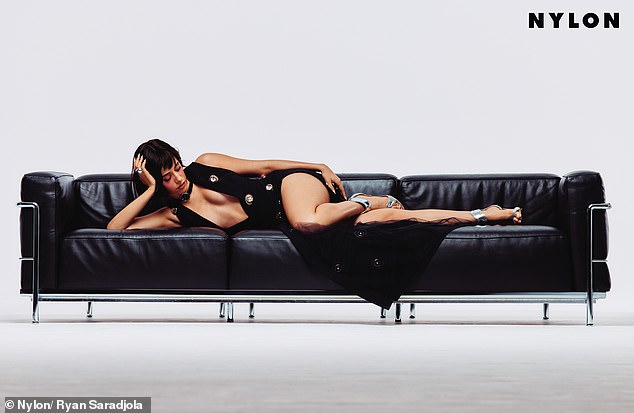 The star posed on a sofa in a plunging dress