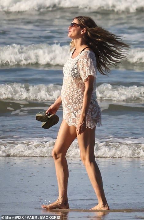 Her baby bump was visible as she walked towards the ocean