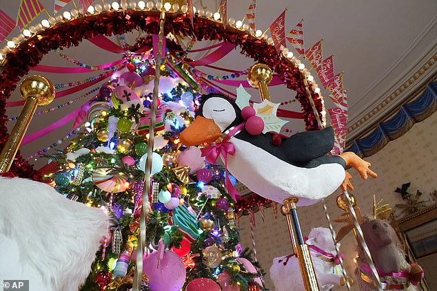 The official White House Christmas tree was hidden behind a carousel of animals such as a reindeer, fox, penguin, duck and more, and a ribbon was hung from the top to mimic the look of a circus tent. Carnival music played during the visitors made its way through the decorations