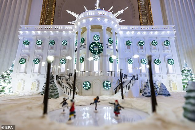 The replica of the White House gingerbread house is made from 25 sheets of gingerbread dough, 10 sheets of sugar cookie dough, 65 pounds of hard icing, 45 pounds of chocolate, 50 pounds of royal icing and 10 pounds of gum paste