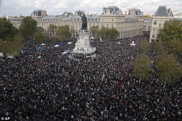 Hundreds of people gather in Republique Square during a demonstration on Sunday, October 18, 2020 in Paris in support of freedom of expression and to pay tribute to a French history teacher who was beheaded near Paris