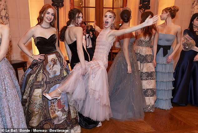 Apple (far right), 20, wows at the prestigious Le Bal des Débutantes on Saturday, but social media users appear more focused on one of the other women who attended the elite event (far left)