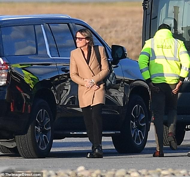 The Australian musician, who is more often seen in a black leather jacket or black tuxedo, paired the tailored jacket with black trousers and black work boots for the chilly New York day