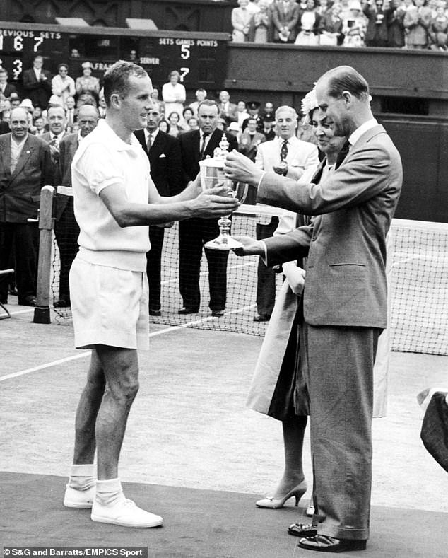 Neale receives the Wimbledon trophy from Prince Philp when he was Duke of Edinburgh