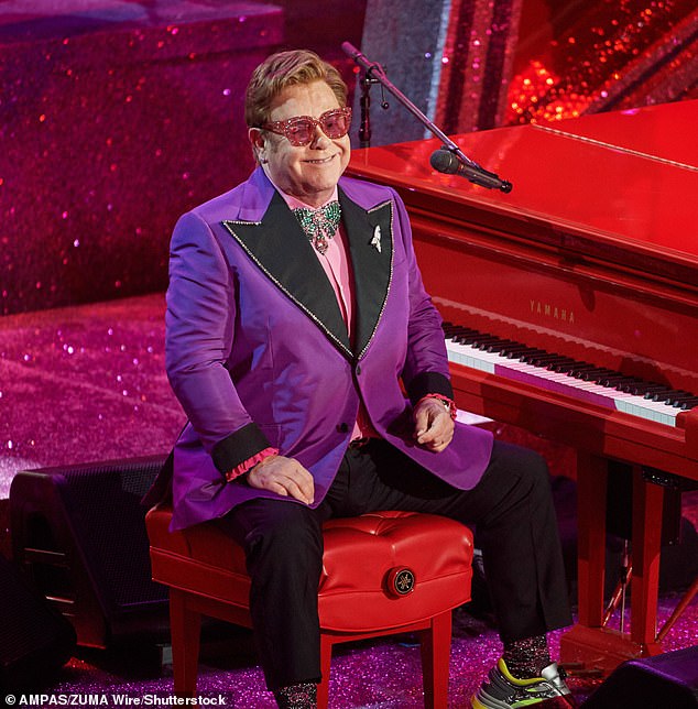 Now a source has said: 'Elton's friends are seriously concerned about the amount he has taken on and believe it is having a major impact on his health' (pictured 2020)