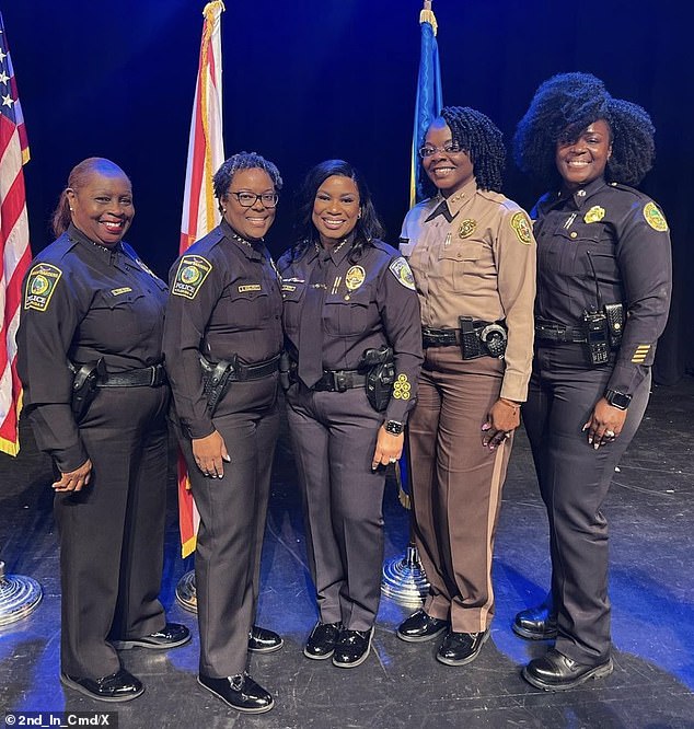 “He compared my haircut to another black female officer with a shorter cut, implying that I was less professional because of the way I chose to wear my hair,” claims Francois, far right, in her suit