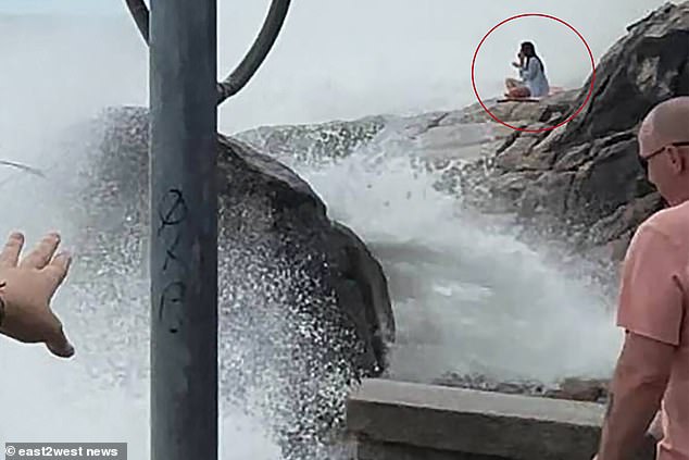 She was seen sitting on her yoga mat as the waves grew stronger