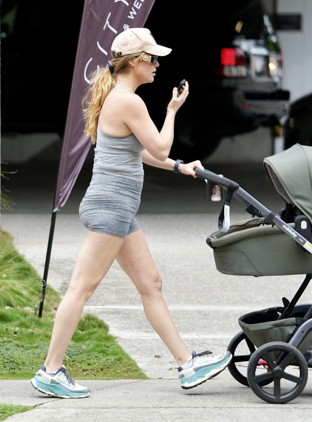 She wheeled her son in a stroller as she walked down the street taking a phone call and wearing designer sunglasses