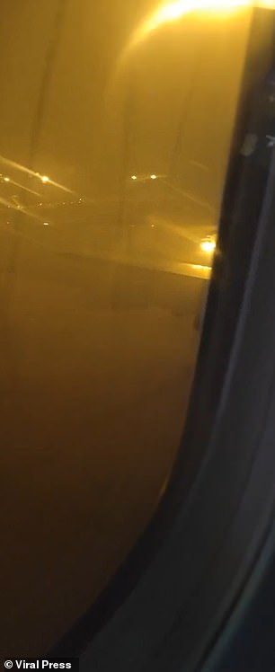 After the plane landed, passengers waited for emergency services as they watched the fire