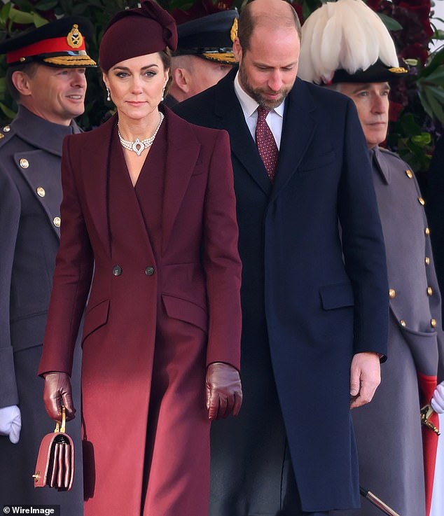 She did this by wearing the exact colors of the Qatari flag: burgundy through her coat dress, hat and boots, and white through her pearl jewelry.