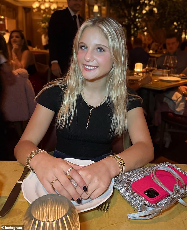 The proud mother shares a beaming snapshot of her daughter sitting at a dining table