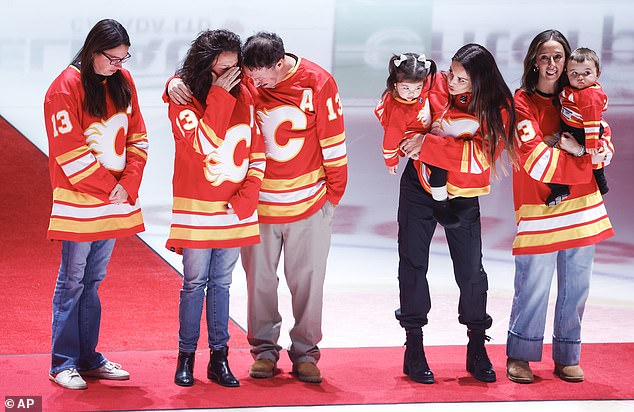 Johnny Gaudreau's family gathers at center ice prior to an NHL hockey game between the Calgary Flames and Columbus Blue Jackets in Calgary