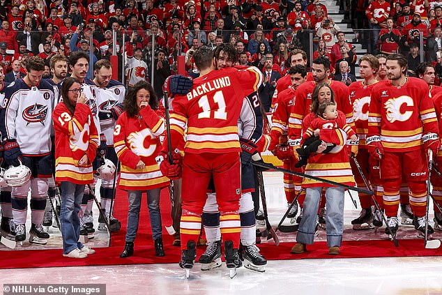 Mikael Backlund hugs former teammate and now member of the Blue Jackets Sean Monahan