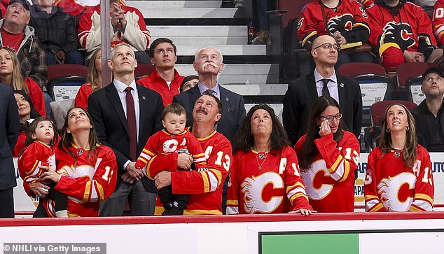 The Gaudreau family watches from the couch during a tribute to Johnny and Matthew Gaudreau