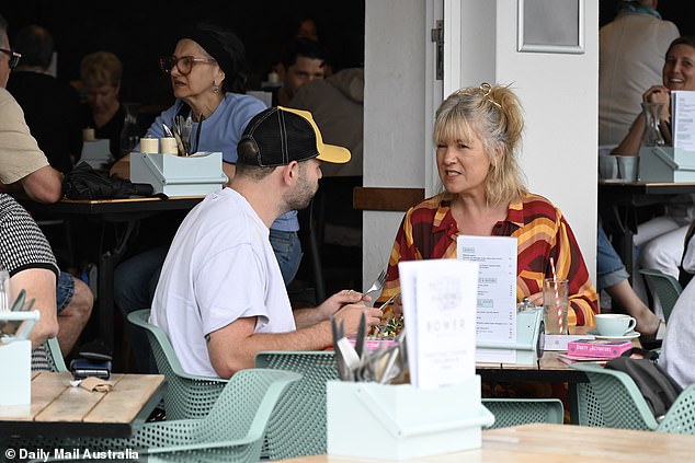 The duo appeared deep in conversation as they enjoyed a meal at a bustling seaside cafe