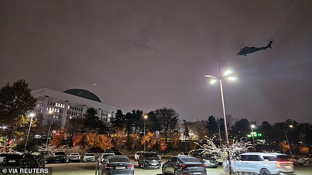 A helicopter flies around the National Assembly Hall after South Korean President Yoon Suk Yeol declares martial law in Seoul, South Korea, December 3, 2024