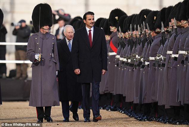 The king and Qatar's Emir Sheikh Tamim bin Hamad Al Thani inspect a guard of honor