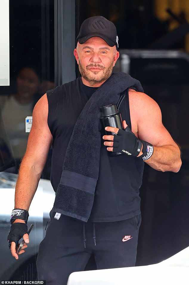 Alex slung a towel over one shoulder, wore fitness bands on each wrist and also carried a mobile device and water bottle