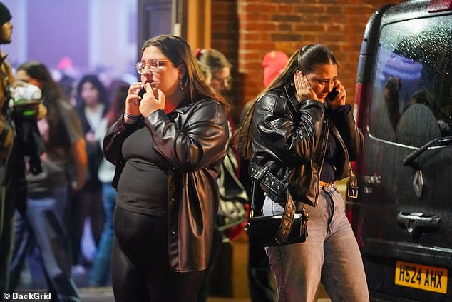 Fans were seen outside the venue on their phones after being told the show had been cancelled