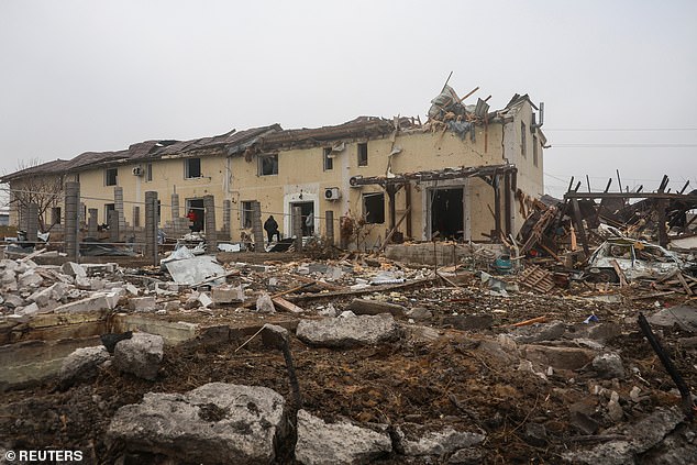 Residents stand next to their house damaged by a Russian missile attack, amid the Russian attack on Ukraine, on the outskirts of Odesa, Ukraine, November 28, 2024