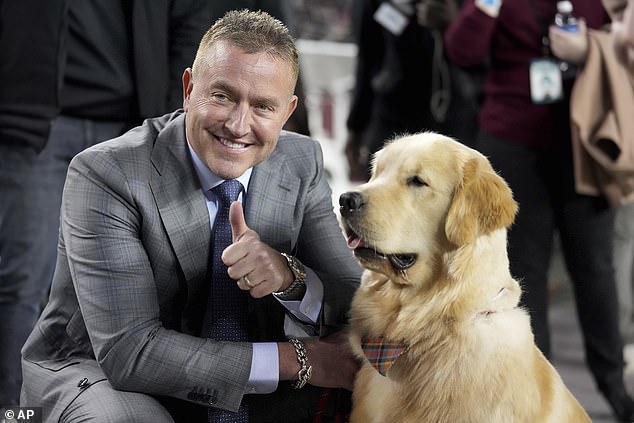 ESPN's Kirk Herbstreit, left, poses with his younger dog Peter before the start of a recent game