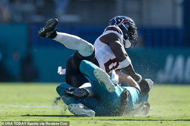 Jacksonville Jaguars quarterback Trevor Lawrence (16) is hit by Houston Texans linebacker Azeez Al-Shaair, who subsequently received a three-game suspension for the illegal tackle