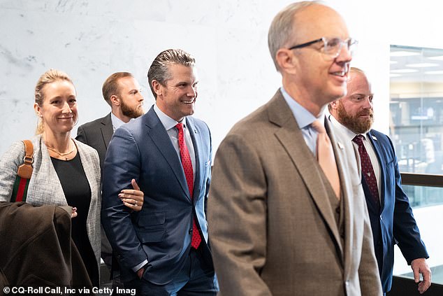 Pete Hegseth, Trump's nominee for Secretary of Defense, walks with his wife Jennifer Rauchet to his meeting with Sen. Mike Rounds, R-S.D., Thursday, December 5, 2024