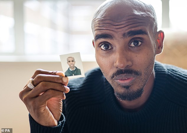 Sir Mo Farah holds up a photo of himself as a child during the filming of the BBC documentary The Real Mo Farah, which airs on Wednesday evening