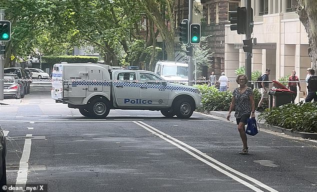 Macleay Street in Potts Point and the area around the Commonwealth Bank branch were cordoned off by police on Friday morning. A police car can be seen at the scene