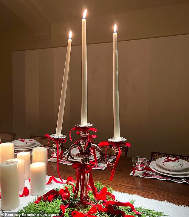 One photo she shared showed a silver candlestick, decorated with festive red bows, and three flickering candles. While two stood upright, the third leaned heavily to one side