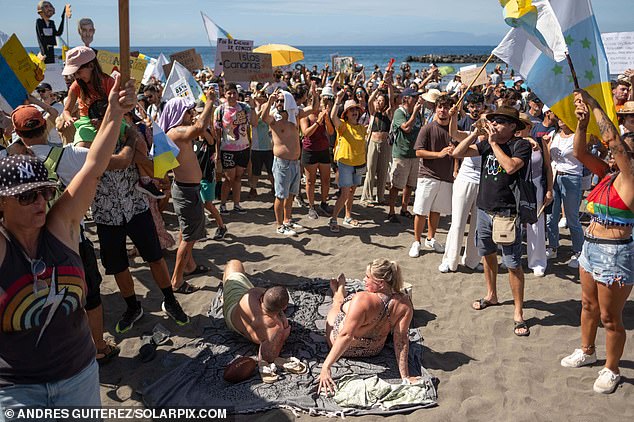 Noisy protesters stormed a Tenerife beach in October during another march against mass tourism, as shocked holidaymakers sunbathing under blue skies looked on