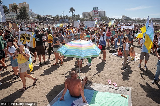 Holidaymakers have been targeted by a gang of sign-wielding locals furious at the current tourism model