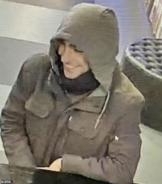 Thompson, 50, who was shot Wednesday on his way to an appearance at an investor conference in New York. The NYPD released this photo of a 'person of interest in the case'