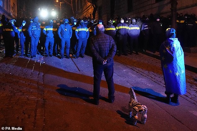 Police hold back demonstrators during a rally outside parliament (Pavel Bednyakov/AP)