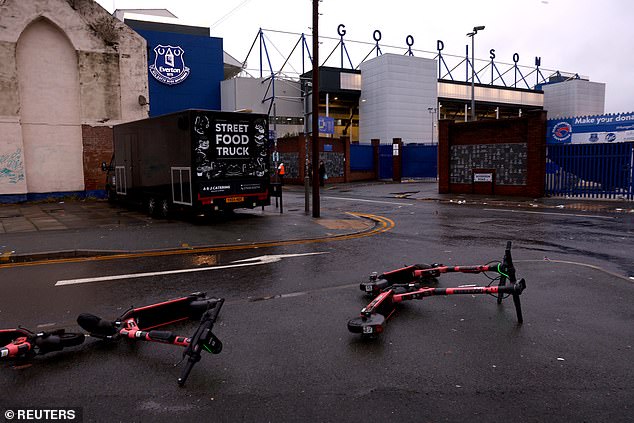 E-scooters are scattered on the pavement outside Goodison Park, where Liverpool were due to play Everton on Saturday