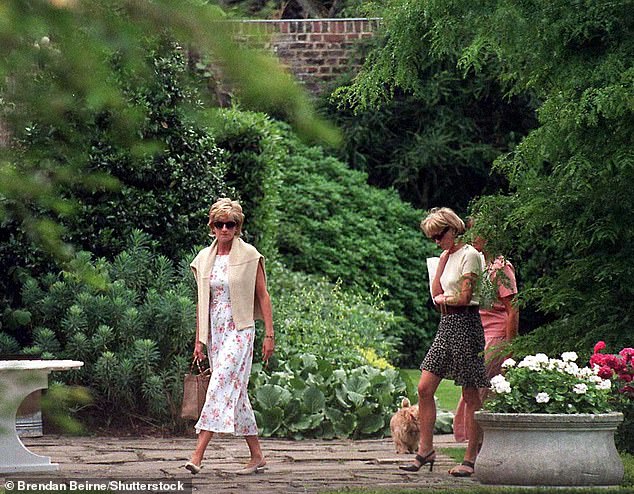 Princess Diana and Victoria Mendham walk in a garden in July 1996