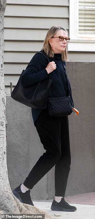 She looked comfortable in a black fleece jacket which she wore with simple black trousers and black trainers