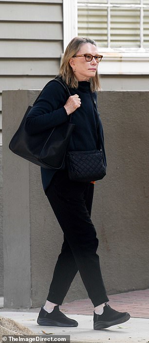 She carried a tasteful quilted black Chanel handbag and also carried a large black leather tote bag