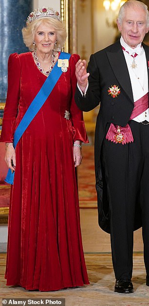 The Queen looked the epitome of elegance in a maroon Fiona Clare dress for a state banquet