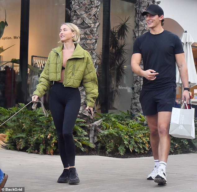 Hough showed off her toned figure in black leggings and a bra top with black sneakers and a chartreuse jacket for warmth in the cool night air. Courtad looked pale in a form-fitting black T-shirt and tennis shorts