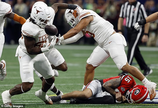 Georgia quarterback Carson Beck (15) is injured on the turf during the first half against Texas