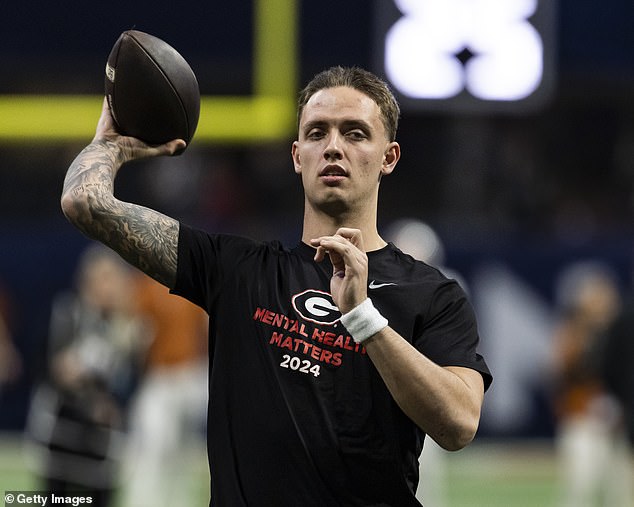 Carson Beck #15 of the Georgia Bulldogs warms up ahead of the 2024 SEC Championship game