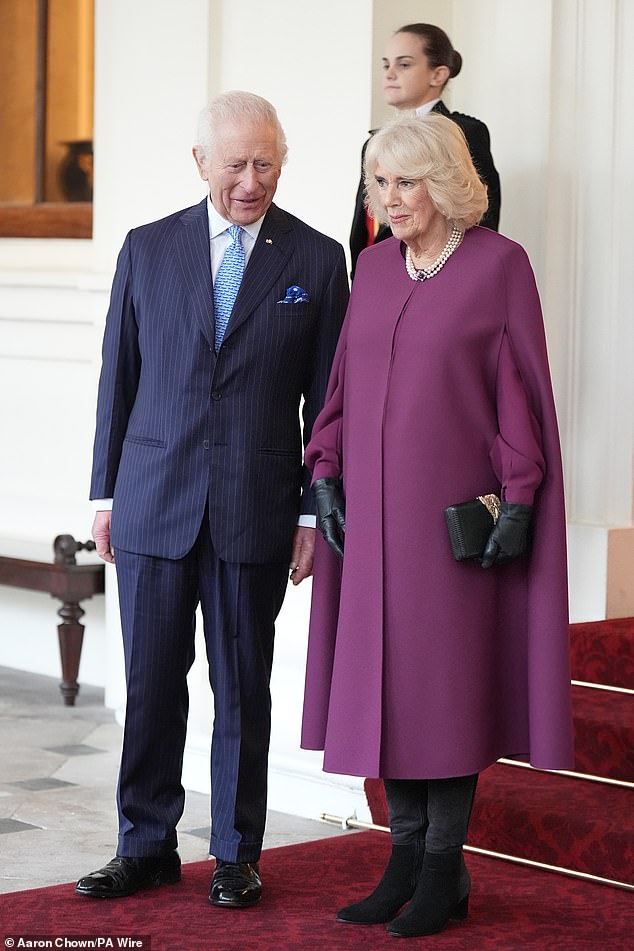 It's a slight departure from the more formal image their Majesties chose last year: an official coronation photo taken by Hugo Burnand in the throne room of Buckingham Palace.