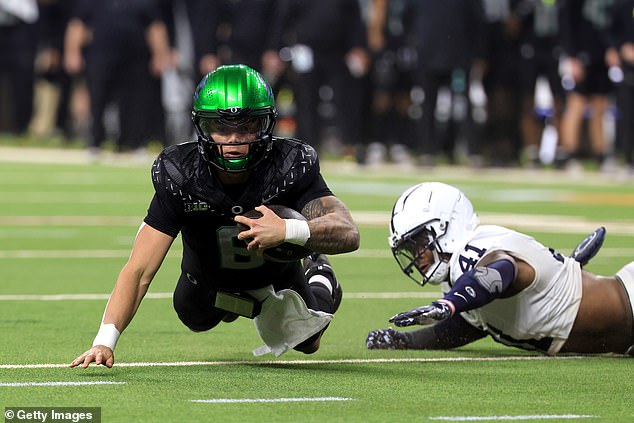 King tackles Oregon Ducks quarterback Dillon Gabriel during the Big Ten Championship game