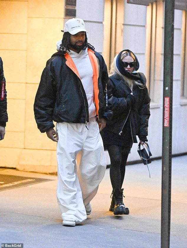 During their outing, the 66-year-old pop star was spotted walking down the street next to the former footballer, 28. For the cold winter weather, she wore an oversized puffer jacket, a chunky sweater, a mini skirt and sheer tights.